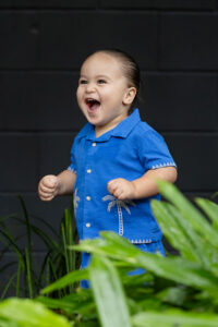 Smiling child playing in garden area during childcare photography session in Zillmere Brisbane
